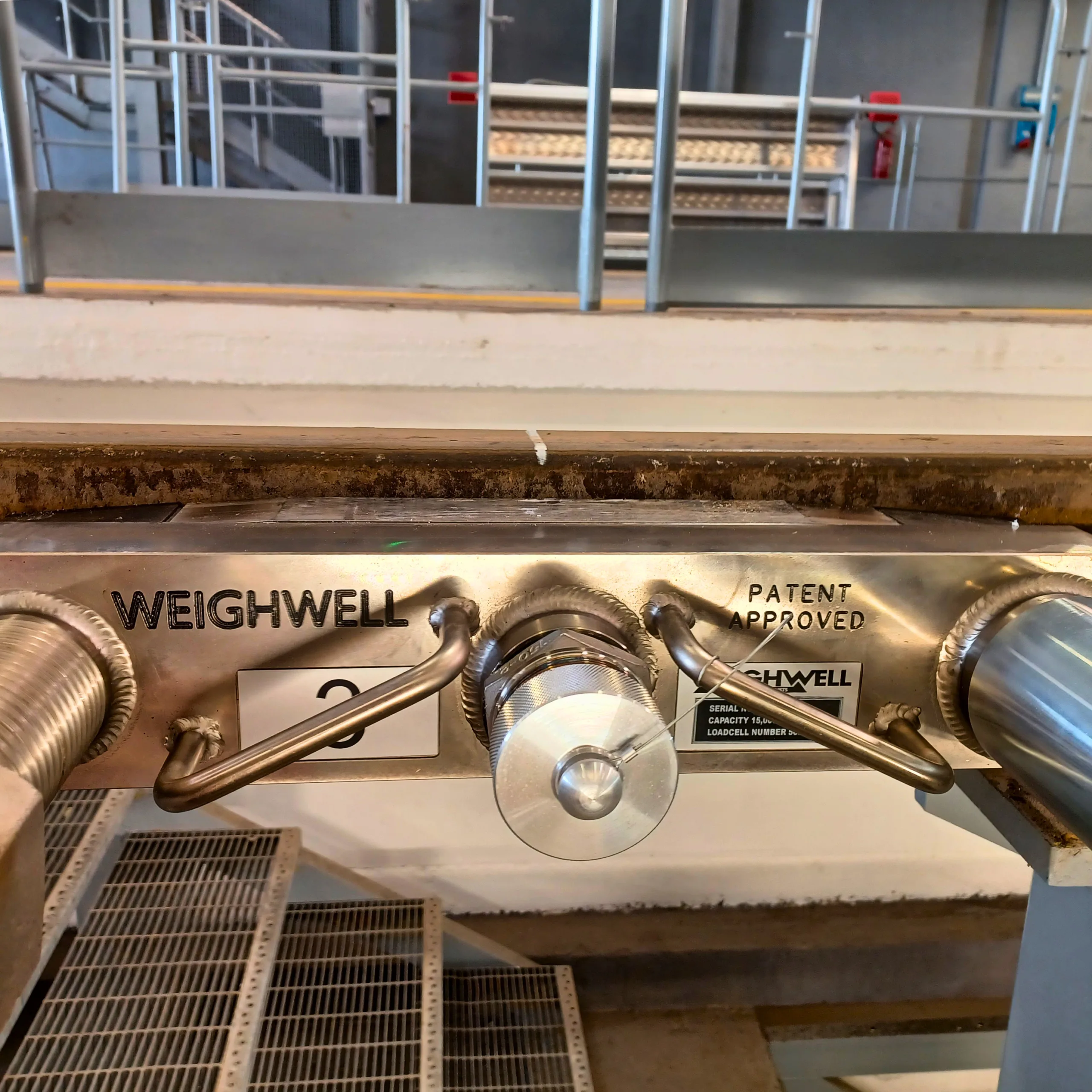 PTW system installed in track with visible “Weighwell” and “Patent Approved” engravings PTW system installed in track with visible “Weighwell” and “Patent Approved” engravings