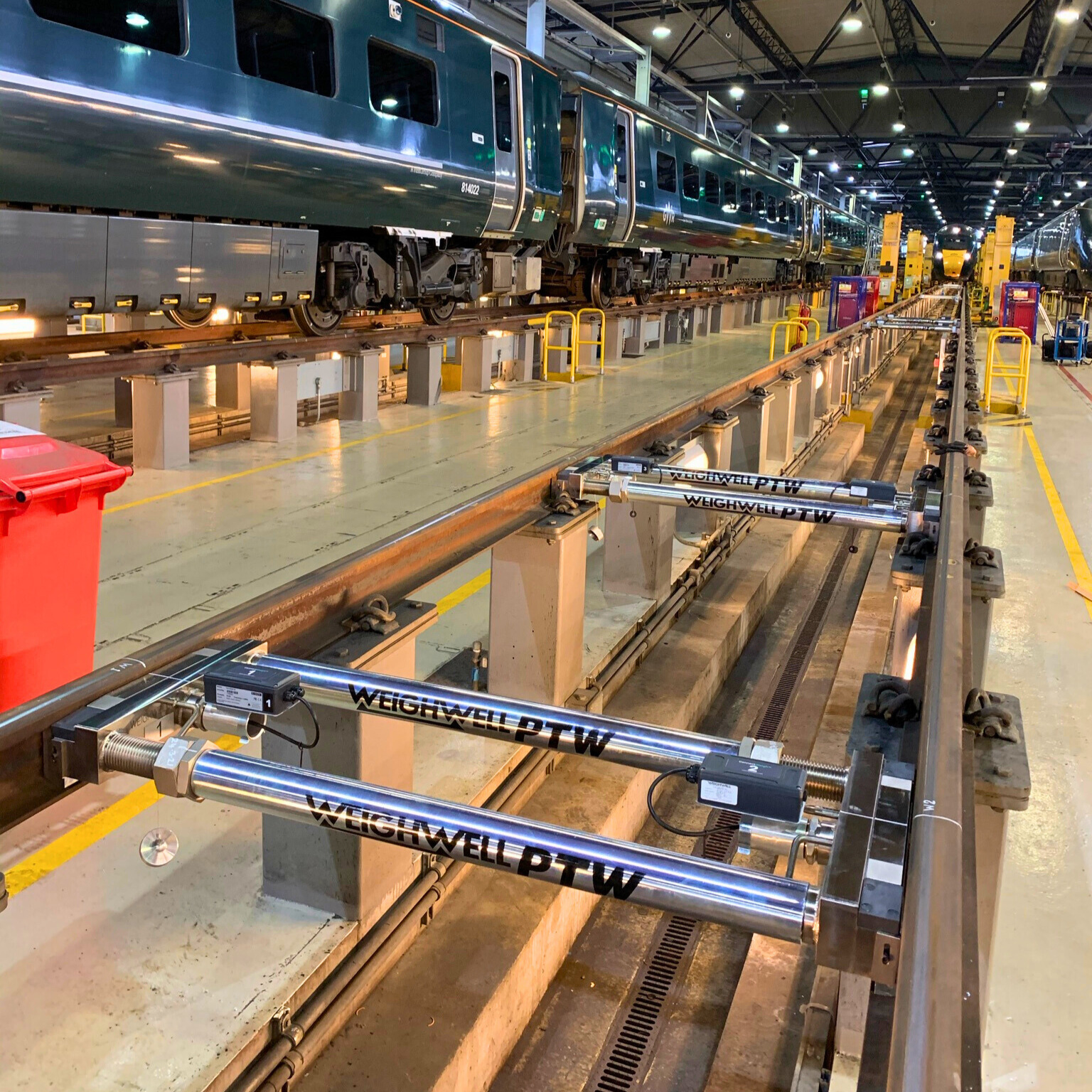 Our Train Weighing Systems at Work Portable Railcar Weighing System installed inside train maintenance depot.