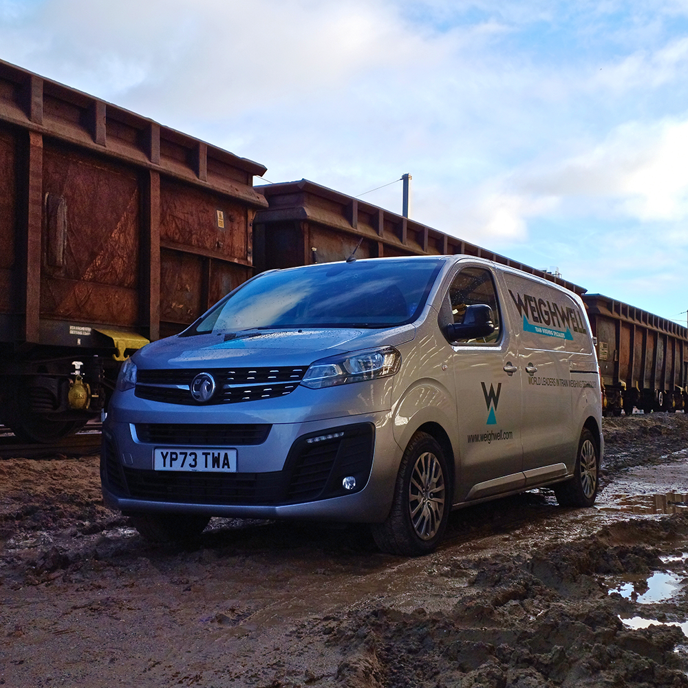 Weighwell van beside freight wagons, indicating portable weighing system hire