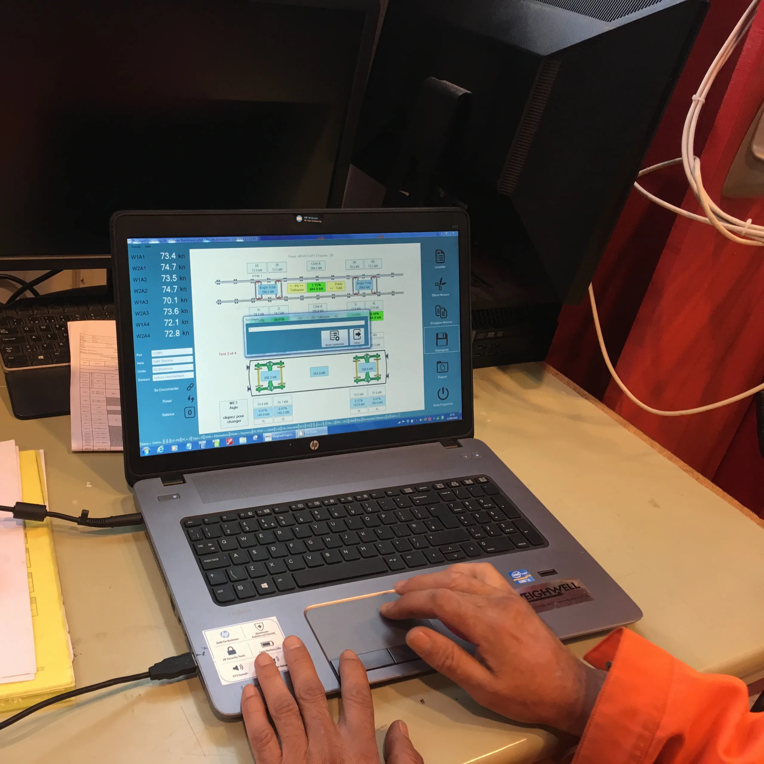transform-your-weighing Technician using ptwX software on a laptop during railcar weighing.