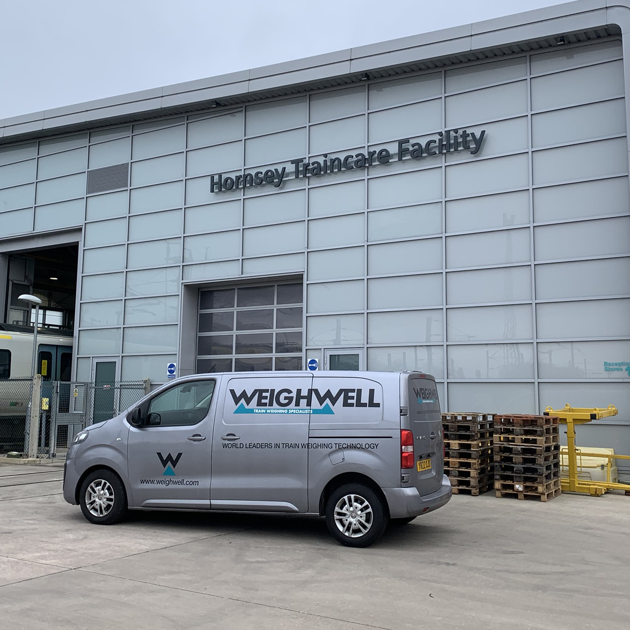 Weighwell van parked outside a railway maintenance facility Weighwell van parked outside a railway maintenance facility
